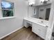 Bathroom vanity featuring a large mirror, ample counter space, and natural light from a window at 124 Creek Hollow Trl, Belmont, NC 28012