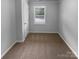 Bedroom featuring neutral carpeting, light gray walls, a window and a door at 124 Creek Hollow Trl, Belmont, NC 28012