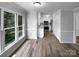 Bright dining area with large windows, seamlessly connected to the kitchen with modern flooring and ample natural light at 124 Creek Hollow Trl, Belmont, NC 28012