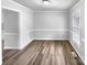 Dining room featuring wood flooring, white wainscoting, natural light and access to other rooms at 124 Creek Hollow Trl, Belmont, NC 28012