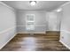 An empty room with hard surface floors, painted walls and a window at 124 Creek Hollow Trl, Belmont, NC 28012