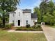 Well-maintained home showcasing its landscaped front yard, driveway, and a detached garage on a sunny day at 124 Creek Hollow Trl, Belmont, NC 28012