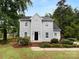 Charming two-story home featuring a well-maintained front yard with mature trees and a classic black front door at 124 Creek Hollow Trl, Belmont, NC 28012