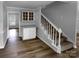 Hallway featuring stairs and a bar and hutch area with white cabinets at 124 Creek Hollow Trl, Belmont, NC 28012