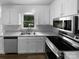 Efficient kitchen with stainless steel appliances, ample counter space, and natural light from the window above sink at 124 Creek Hollow Trl, Belmont, NC 28012