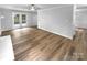 Open living room featuring wood flooring, light gray walls, and access to a deck at 124 Creek Hollow Trl, Belmont, NC 28012