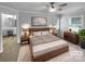 Serene main bedroom featuring a modern bed frame, soft carpeting, and ample natural light at 124 Creek Hollow Trl, Belmont, NC 28012