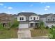 Two-story home with a two-car garage, landscaped yard, and neighborhood view at 12536 Stoneybrook Pkwy, Huntersville, NC 28078