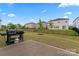 Backyard with patio, grill, fence, and grass at 12536 Stoneybrook Pkwy, Huntersville, NC 28078