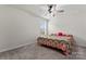 Bright bedroom with ceiling fan, carpet, and window at 12536 Stoneybrook Pkwy, Huntersville, NC 28078