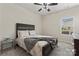 Bedroom with neutral tones, a wooden bed frame, carpet, and a window providing natural light at 12536 Stoneybrook Pkwy, Huntersville, NC 28078