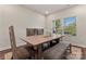 Bright dining area with wooden table and chairs, large windows overlooking outside, and hardwood floors at 12536 Stoneybrook Pkwy, Huntersville, NC 28078