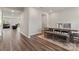 Dining room with a wooden table and bench, set on a decorative rug, and hardwood floors at 12536 Stoneybrook Pkwy, Huntersville, NC 28078