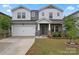 Charming two-story home with a two-car garage and stone veneer accents at 12536 Stoneybrook Pkwy, Huntersville, NC 28078