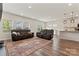 Open-concept living room with hardwood floors and a view of the kitchen at 12536 Stoneybrook Pkwy, Huntersville, NC 28078