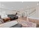 Bright living room with hardwood floors, a fireplace, and a view of the kitchen at 12536 Stoneybrook Pkwy, Huntersville, NC 28078