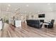 Spacious living room with hardwood floors, a fireplace, and a flat-screen TV at 12536 Stoneybrook Pkwy, Huntersville, NC 28078
