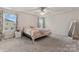 Main bedroom with a large window, neutral walls, carpet floors, and a ceiling fan at 12536 Stoneybrook Pkwy, Huntersville, NC 28078
