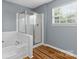 Relaxing bathroom featuring a corner soaking tub and separate glass shower at 126 Rocky Trail Ct, Fort Mill, SC 29715
