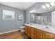 Bathroom featuring double sink vanity, large mirror and a bright window at 126 Rocky Trail Ct, Fort Mill, SC 29715
