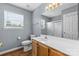 Bright bathroom with vanity, white sink, toilet, and shower with glass door at 126 Rocky Trail Ct, Fort Mill, SC 29715