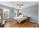 Charming bedroom features wood floors, blue walls, a ceiling fan, and natural light at 126 Rocky Trail Ct, Fort Mill, SC 29715