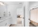 Bright bathroom featuring a white vanity and access to another bathroom and bedroom at 126 Still Creek Dr, Mooresville, NC 28115