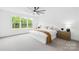 Sun-filled bedroom features plush carpet and large windows overlooking a wooded area at 126 Still Creek Dr, Mooresville, NC 28115