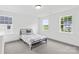 Bright bedroom featuring two large windows, carpeted floors, and a bed with patterned sheets at 126 Still Creek Dr, Mooresville, NC 28115