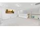 Spacious bonus room with white walls, plush carpet, and an open staircase at 126 Still Creek Dr, Mooresville, NC 28115