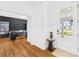 Bright entryway featuring hardwood floors, modern decor, and an office space with accent wall at 126 Still Creek Dr, Mooresville, NC 28115