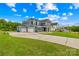 Charming blue home with a three-car garage, green lawn, and inviting front porch at 126 Still Creek Dr, Mooresville, NC 28115