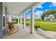 Inviting covered front porch with rocking chairs, American flag, and manicured landscaping at 126 Still Creek Dr, Mooresville, NC 28115