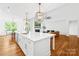 Bright kitchen with large island and view to the dining and living areas at 126 Still Creek Dr, Mooresville, NC 28115