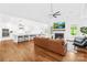 Open-concept living room featuring hardwood floors, modern fireplace, and view of the kitchen at 126 Still Creek Dr, Mooresville, NC 28115