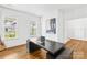 Bright, contemporary office with hardwood floors, large windows, and stylish desk at 126 Still Creek Dr, Mooresville, NC 28115