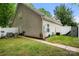 Spacious backyard showcasing a well-kept lawn, patio area, and side view of the home at 12663 Windyedge Rd, Huntersville, NC 28078