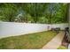 Private backyard featuring a well-maintained lawn, white fence, and patio furniture for relaxation at 12663 Windyedge Rd, Huntersville, NC 28078