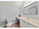Bright bathroom with a built-in vanity, a large mirror, and a toilet for convenience and comfort at 12663 Windyedge Rd, Huntersville, NC 28078