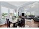 Bright dining area featuring hardwood floors, a wooden table, and an open layout to the living room at 12663 Windyedge Rd, Huntersville, NC 28078