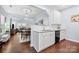 Open concept kitchen with white cabinets, stainless appliances, granite countertops, and dark wood floors at 12663 Windyedge Rd, Huntersville, NC 28078