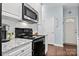 The kitchen features white cabinets, stainless appliances, granite countertops, and a tile backsplash at 12663 Windyedge Rd, Huntersville, NC 28078