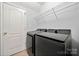 Well-lit laundry room equipped with modern washer and dryer, offering convenience for laundry tasks at 12663 Windyedge Rd, Huntersville, NC 28078