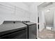 Functional laundry area with modern appliances and shelving for organizing essentials at 12663 Windyedge Rd, Huntersville, NC 28078