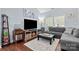 Bright living room featuring hardwood floors, a modern fireplace, and contemporary furnishings at 12663 Windyedge Rd, Huntersville, NC 28078