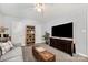 Comfortable living room with a flat-screen TV, stylish furniture, and a modern ceiling fan for added comfort at 12663 Windyedge Rd, Huntersville, NC 28078