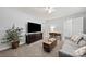 Spacious living room features a mounted television, wood floors, a sofa, and neutral paint at 12663 Windyedge Rd, Huntersville, NC 28078