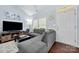Comfortable living room boasting a stylish sectional sofa, modern décor, and plenty of natural light at 12663 Windyedge Rd, Huntersville, NC 28078