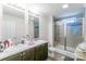 Bathroom featuring a dual vanity and a walk-in shower with a glass door at 1316 Wiscassett St, Albemarle, NC 28001