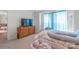 Bright bedroom showcasing television atop a wooden dresser, and window view with blue curtains at 1316 Wiscassett St, Albemarle, NC 28001